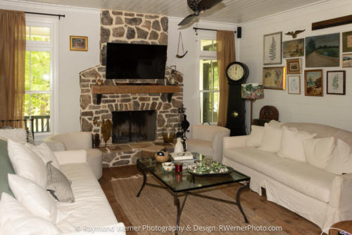 The Farm at Little Fox Hollow Main Sitting Room with a fireplace and a grandfather clock.